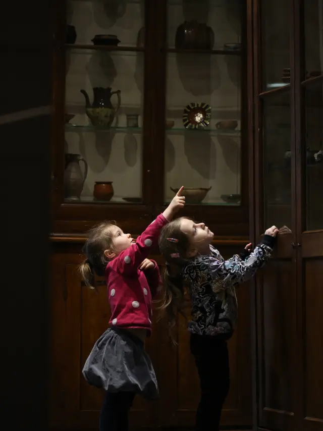 Deux enfants observent des céramiques anciennes en vitrine au Musée de la Céramique à Lezoux